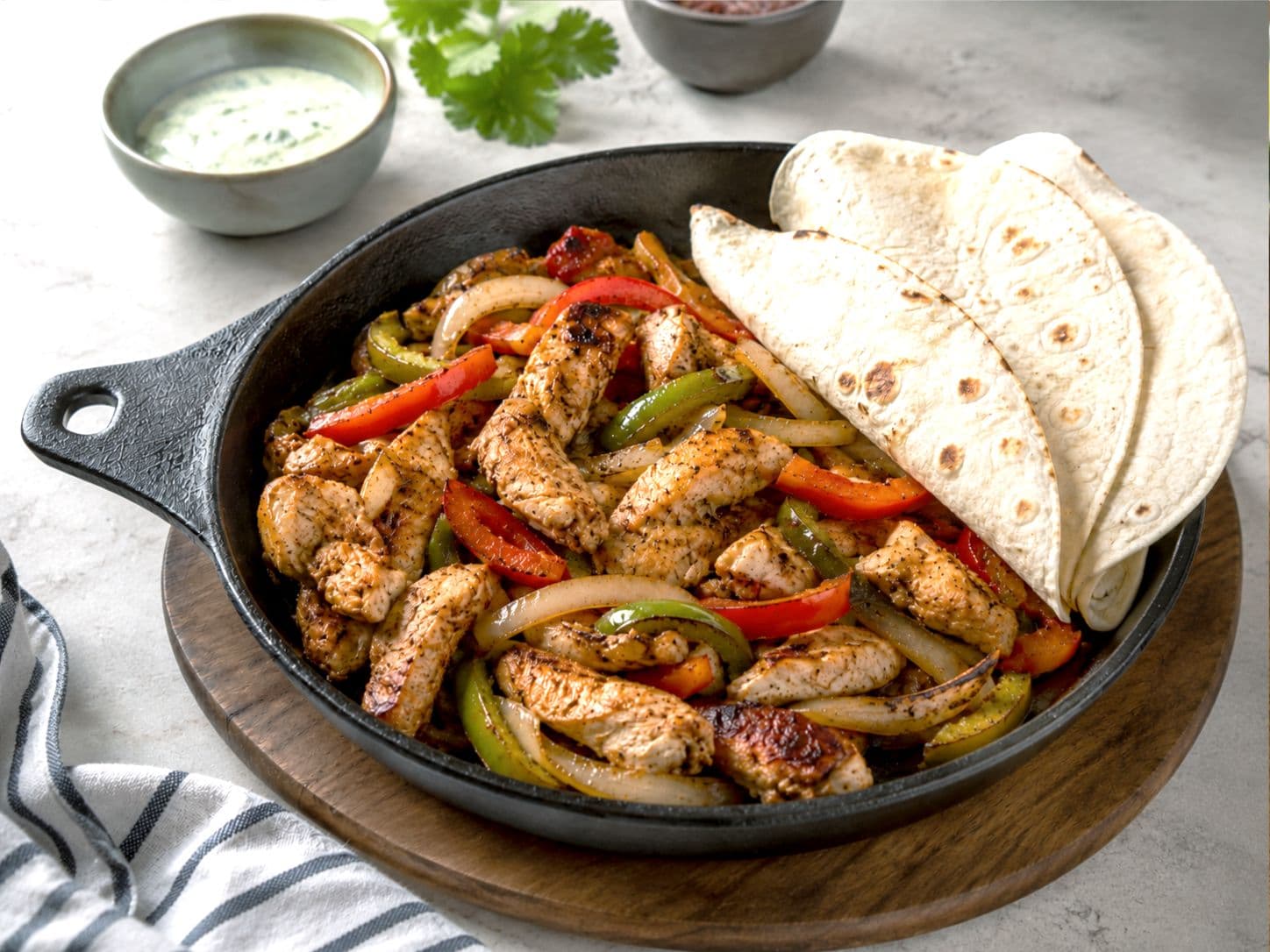 Sizzling Chicken Fajitas with Chihuahua Cheese & Cilantro Cream